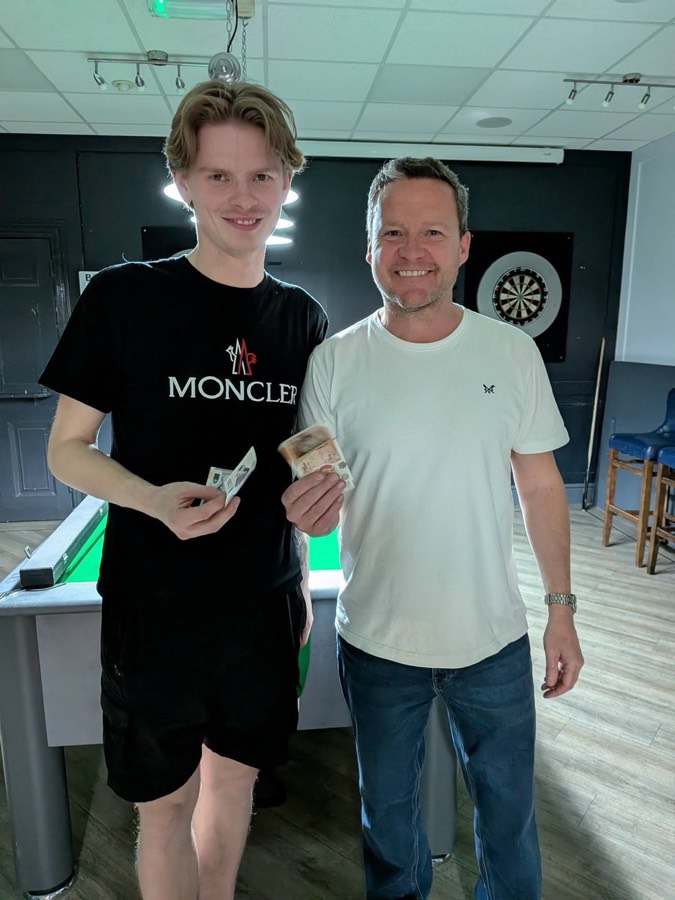 Two Evolve money match players holding their cash winnings beside the table after a head to head at a local club
