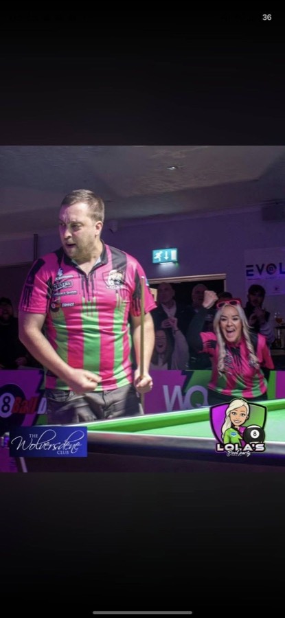 Player in Lola's Pool Party colours celebrating a winning frame in front of the crowd at the Wolversdene Club